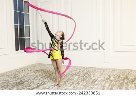 Sport training beautiful girl with Pink Rhythmic gymnastics ribbon in white room jumping and doing professional exercises