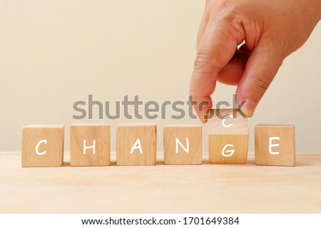 Change and chance on wooden cube concept. Hand pick G or C in change and chance on wooden cube.