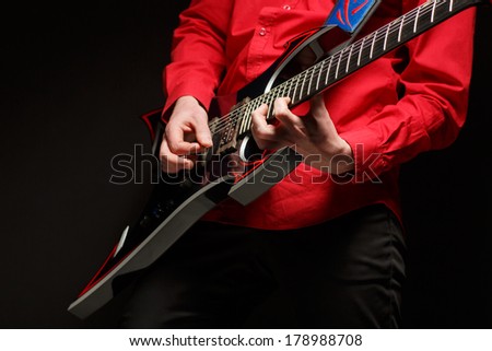 Rock guitarist plays solo guitar.