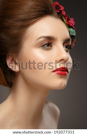 Beautiful girl with trendy makeup. Wreath of flowers in her hair. Clean skin.
