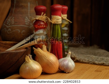 Spices assortment on a wooden table. Onions and garlic. Shallow depth of field.
