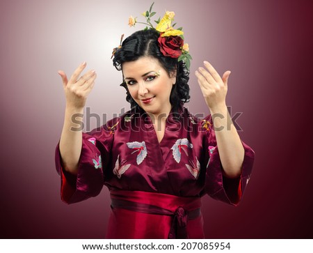 Kimono attractive mature woman asking you to come in. Portrait on gradient background