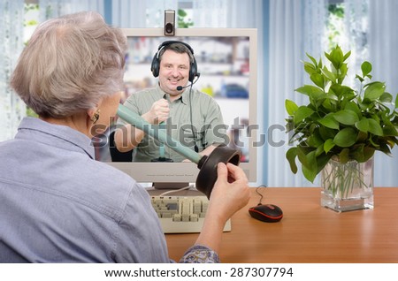 Virtual plumber explains how to unclog a drain to senior woman. Grey haired woman asks him during on-line session in internet