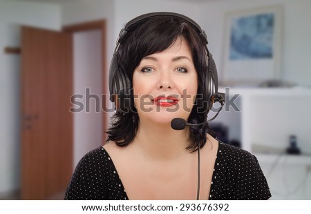 Black haired woman in headset working with e-learning language company. She is bilingual teacher