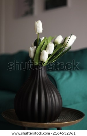 Similar – Image, Stock Photo artificial white tulips and green leaves in a black vase on the table in home interior.