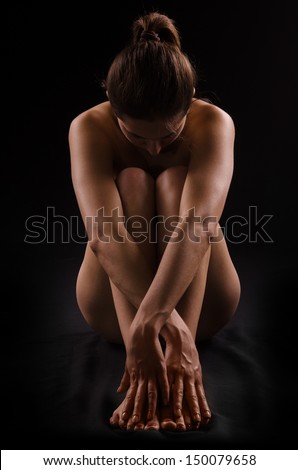 silhouette of a nude female figure on black background