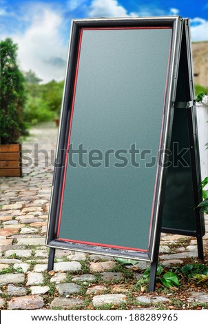 Empty menu board standing on the street and  blured background