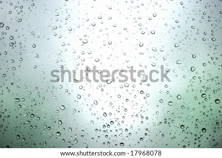 rain drops on a window and mystic silhouette of city