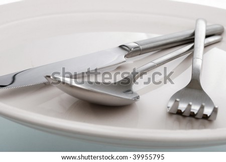 empty kitchen plate, fork, spoon and table-knife