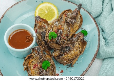 Similar – Image, Stock Photo Delicious baked artichokes on black plate