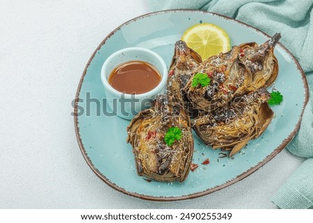 Similar – Image, Stock Photo Delicious baked artichokes on black plate