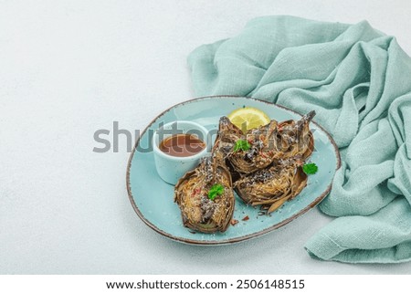 Similar – Image, Stock Photo Delicious baked artichokes on black plate