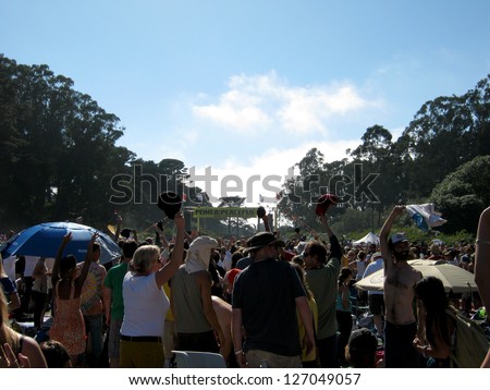 SAN FRANCISCO - SEPTEMBER 11: People raise their hats and hands into the air as Michael Franti and Spearhead Plays at Power to the Peaceful 2010. September 11, 2010 at Golden Gate Park San Francisco.