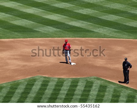 OAKLAND, CA - JUNE 10: Angels Hideki Matsui stands on second base with second base umpire in frame.  Baseball game June 10 2010 at the Coliseum in Oakland, California.