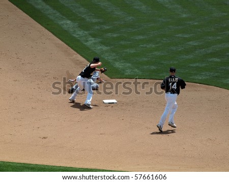 OAKLAND, CA - JULY 21: Red Sox vs. Athletics: As Cliff Pennington turns to throw to first after stepping on second during double play.  Taken on July 21, 2010 at the Coliseum in Oakland California.