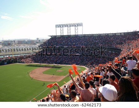 SAN FRANCISCO - OCTOBER 2: Padres vs. Giants: Fans wave orange towels to celebrate giants hit on offense.  taken on October 2 2010 at Att Park in San Francisco California.