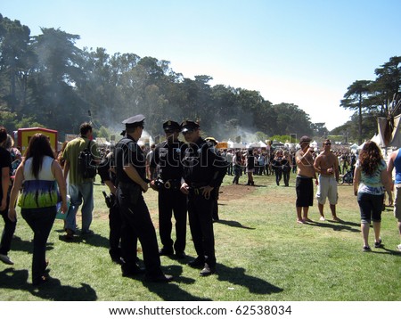SAN FRANCISCO - SEPTEMBER 11: Four SFPD officers stand together talking as they supervise events at Power to the Peaceful 2010 Music Festival.  September 11, 2010 Golden Gate Park San Francisco.