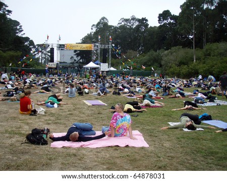 SAN FRANCISCO, CA - SEPTEMBER 8: People stretch out doing yoga outdoors at Power to the Peaceful 2007 Music Festival.  Taken September 8, 2007 at Golden Gate Park San Francisco.