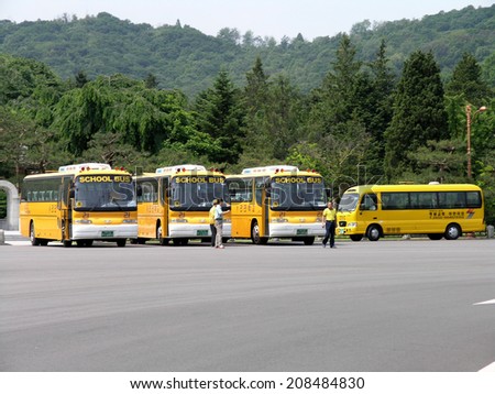 SEOUL, SOUTH KOREA - MAY 31: South Korean School Buses in parking lot. The School Bus transport the student body population to and from school.   Seoul, South Korea, May 31, 2005.
