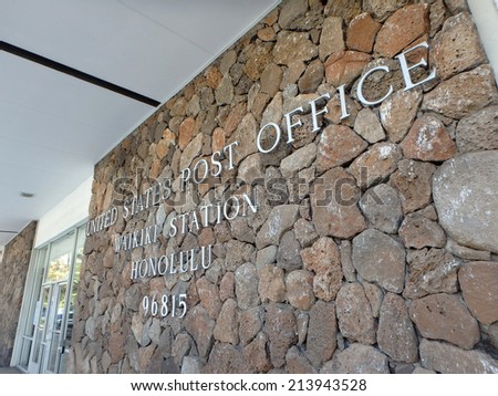 HONOLULU - JULY 25: Metal letters that spell United States Post Office, Waikiki Station, Honolulu, 96815 by entrance, fastened on lava rocks on the side of a building. Waikiki, Hawaii July 25, 2014