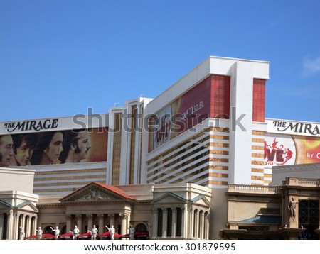 LAS VEGAS - JUNE 29: The Mirage hotel and Casino with ad for Beatles show wrapping windows.  The Mirage is one of the most famous hotel on Las Vegas Strips, June 29, 2015.