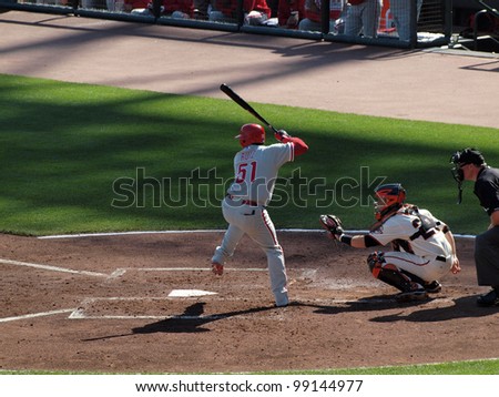SAN FRANCISCO, CA - OCTOBER 19: Phillies Carlos Ruiz steps forward to hit pitch with Catcher Buster Posey squatting ready to catch game 3 NLCS 2010 October 19, 2010 AT&T Park San Francisco.