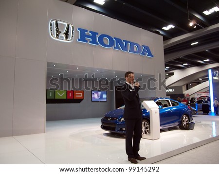 SAN FRANCISCO, CA - NOVEMBER 23: Man talks about Honda cars at booth at the 54rd International Auto Show November 23 2011 San Francisco.