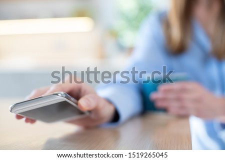 Woman Concerned About Excessive Use Of  Social Media Laying Mobile Phone Down On Table Foto stock © 