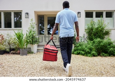 Rear View Of Gig Economy Driver Delivering Online Takeaway Food Order To House Photo stock © 