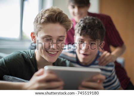 Similar – Image, Stock Photo Focused boy watching films on tablet