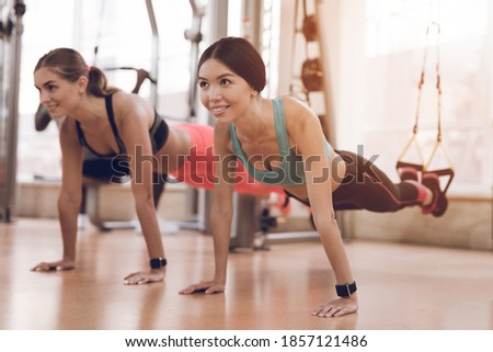 Athletes do exercises in a modern gym with modern simulators. They are in the gym and focused on the exercises. Foto stock © 
