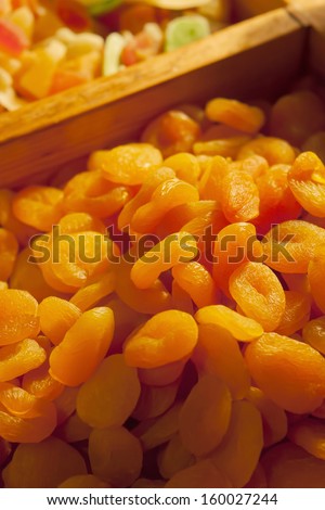 Dried apricots on market/Sweet dried apricots and similar dried fruit. Delicious dried food arranged in rows.