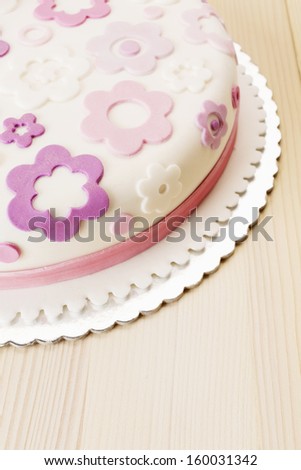 Fondant flower cake/Flower themed cake on wooden table.Female cake.