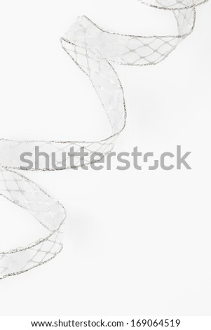 Decorative bow/Holiday elegant bow. White bow with silver thread on white background. Holiday background.