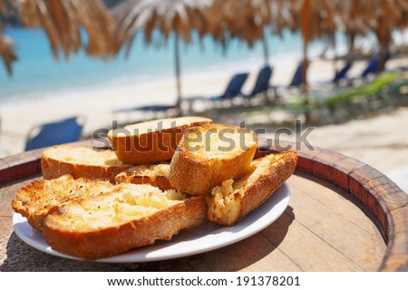 Traditional Mediterranean food. Tasty snack food on seaside wooden table/Baked bread with olive oil