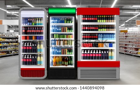 Soda pop drinks and soft drinks in Fridge.
Glass door fridge Horizontal photo mockup Soda pop cans and plastic bottles in vertical freezer at supermarket. Suitable for presenting new cans and bottles