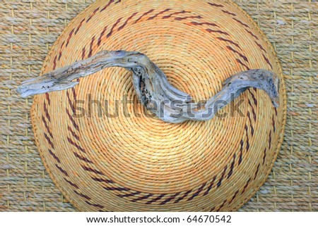 Organic materials including drift  wood  and African basket on organic background.