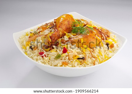 Chicken biryani , kerala style chicken dhum biriyani made using jeera rice and spices arranged in a white ceramic table ware with white background, isolated
