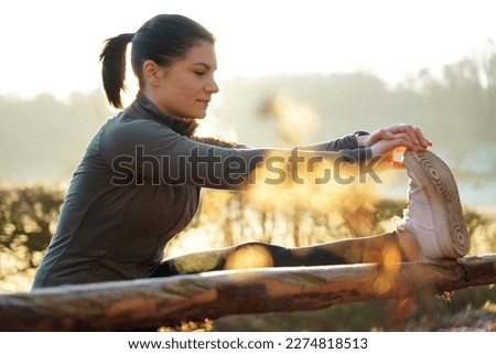 Similar – Woman stretching after running