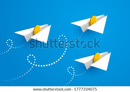 White paper airplanes with gold coins inside are flying forward over blue sky background. Concept of money transfers, transactions, online payments, successful business and startup