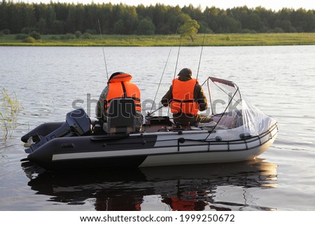 Similar – Image, Stock Photo two fishermen in a boat with reflection in a still river water at twilight on autumn landscape.