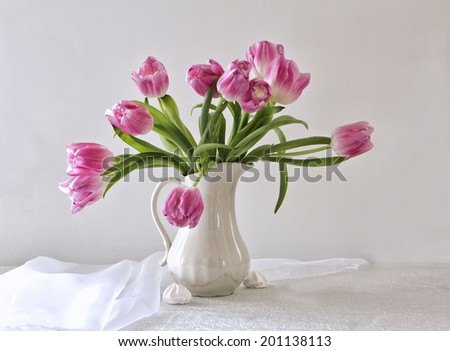 photo bouquet of pink tulips in a white vase on a white background