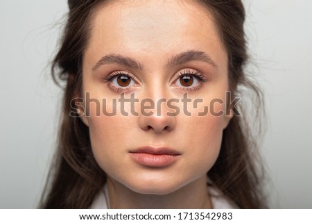 Similar – Image, Stock Photo Close portrait of a young woman standing behind a sliding gate and looking through it