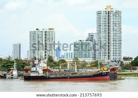 BANGKOK, THAILAND - AUGUST 28: Cargo ship on the side of the Chao Phraya river, Bangkok, Thailand on August 28, 2014.   Chao Phraya river is the principal river of Thailand.