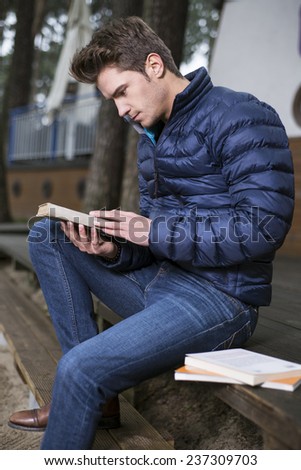 Handsome young man with a book