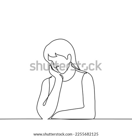 woman sits at a table or by a window with her head slightly lowered which rests on her palm - one line drawing vector. concept she is sad, daydreaming, has a headache or is tired