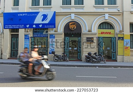 HANOI, VIETNAM - SEP 10, 2014: Front view of UPS and DHL offices locating near a local postal and delivery service in Hanoi capital.
