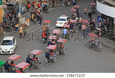 Hanoi, Vietnam - Dec 13, 2014: Many personal vehicles traveling on a messy cross street on a typical rush hour in Hanoi capital.