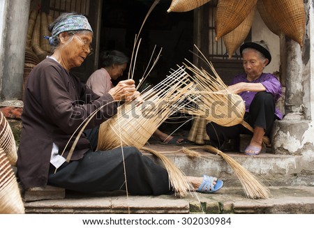 Vietnamese craftsmen making bamboo handicraft products to maintain a traditional handicraft in a countryside of Vietnam. Concept of life in Vietnam