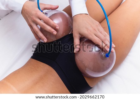Woman using suction cup pump up on her butt to lift it up. Photo stock © 